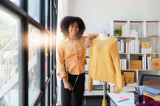 Portrait of young african american woman fashion designer stylish working at fashion studio.