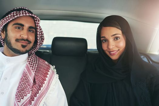 I chose the perfect partner to travel through life with. Portrait of a young arabic couple traveling in a luxury car