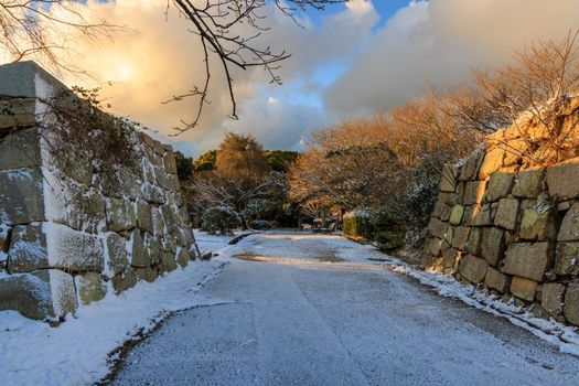 Stone walls of historic castle entrance in frosty morning sun. High quality photo