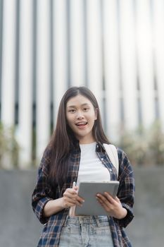 Portrait of beautiful student woman in university ready for learning. Education, scholarship and happy and proud female learner at university.