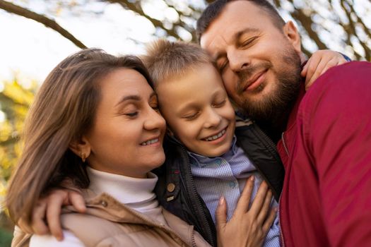 photographs of a happy traditional family close-up portrait of mom dad and baby boy.