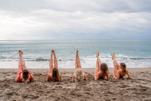 Big happy family or group of five friends is having fun against sunset beach. Beach holidays concept