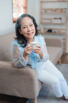 Portrait of an elderly Asian woman drinking tea for health