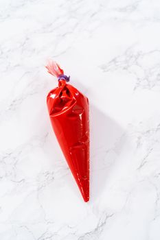 Melted chocolate in a piping bag on the kitchen counter.