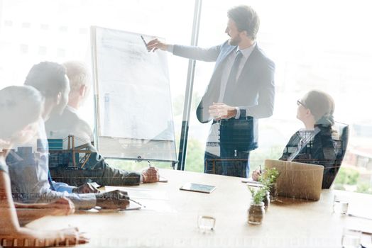 Strategic planning gives them the competitive advantage. Multiple exposure shot of colleagues in a presentation superimposed over an industrial background