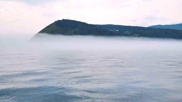 Lake Baikal in Russia in the fog on the background of the mountain