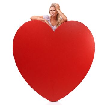 Heart, love and studio portrait of woman with big red object, romantic product or emoji icon for Valentines Day holiday. Beauty, happy smile and relax model girl with care symbol on white background.
