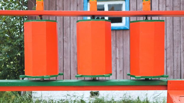 Rotation of the red prayer drums outside the Buddhist temple