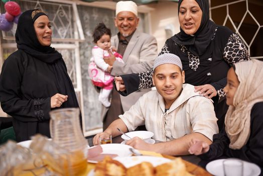 Ramadan is about eating together as a family. a muslim family eating together