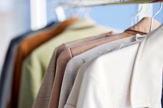Shirts, clothes and closet in a home with fashion, style and organized. Neat, tidy and clean work clothing in a wardrobe for lifestyle, selection and choice in a bedroom for organizing and changing.
