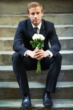 Stairs, portrait and man with flowers for valentines day, romance or gesture while sitting outdoors. Roses, face and gentleman with bouquet for love, anniversary or first date, confident and handsome.