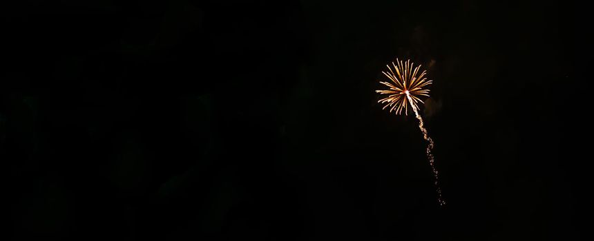 one small fireworks flying in the night sky.Banner,copyspace.
