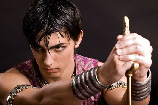 Portrait of young serious man with saber