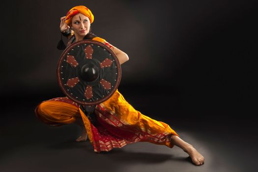 Beauty woman posing with shield - arabian costume