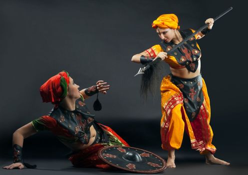 Two woman fight with spear and shield - arabia theme
