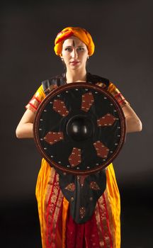 Beauty woman posing with shield - arabian costume