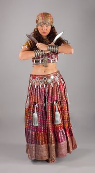 Beauty woman in traditional indian costume dance with knifes