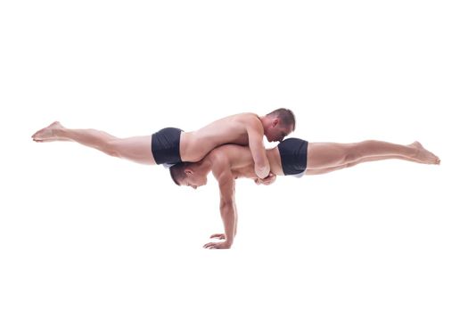 Muscled acrobats keep balance isolated on white