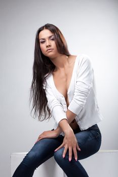 Image of beautiful young woman with long hair, on gray background