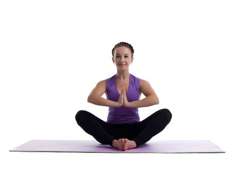 young woman sit in lotos as yoga asana on rubber mat isolated