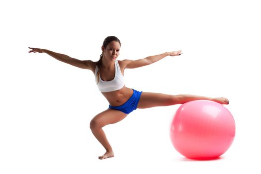 girl with fitness ball doing split isolated