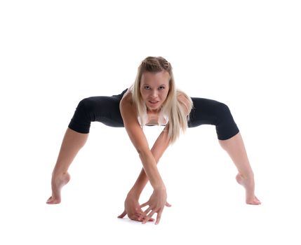 young blond woman stand in spider yoga pose isolated