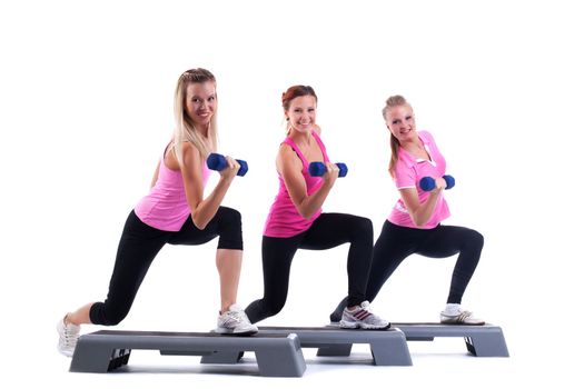 young group training instructor on stepper with dumbbells and smile isolated