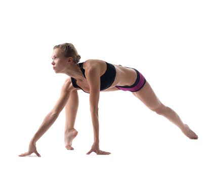 young woman in fitness costume doing split isolated