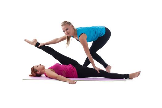 Two young woman - fitness instructor help stretch exercise isolated