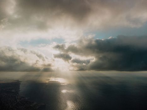 Blue sky with white clouds over calm summer panorama of the sea. Drone aerial view. Abstract aerial nature summer ocean sunset sea and sky background. Horizon. No people. Holiday and vacation concept