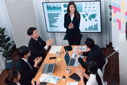 Top widen view of confidence of company presentation on financial analyzed by business intelligence in dashboard report with businesspeople in boardroom meeting to promote harmony in workplace concept