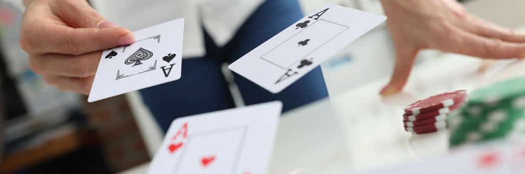 Person throws playing cards on table. Playing poker and gambling in the casino