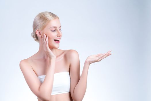 Personable beautiful woman with perfect smooth and clean skin portrait in isolated background. Beauty hand gesture with expressive facial expression for skincare treatment product or spa.