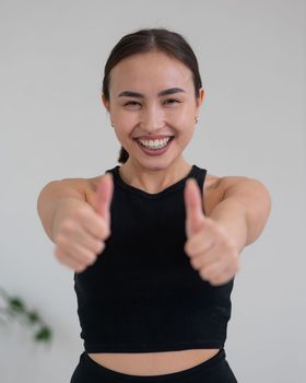 Portrait of beautiful asian woman showing thumb up