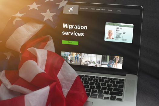 A laptop next to the USA flag. Flag of the United States close up. Concept - US government sites. Concept - Sat on Migration to America. Relocation to the United States. American Internet segment
