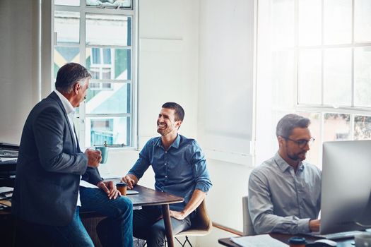 Office building, meeting and business people talking at desk for planning, company success and goals. Corporate workplace, teamwork and employees sitting at table, in discussion and coworking on idea.