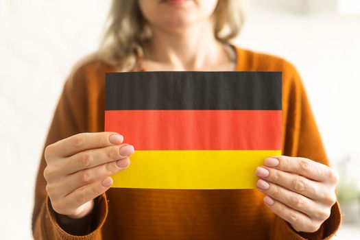 German flag in hands. Modern education, language learning and knowledge exchange