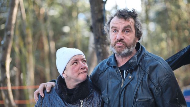 Homeless people are interviewed in the winter in the woods