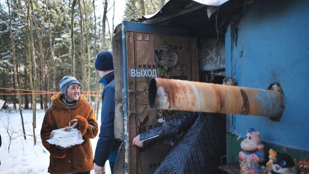 A lonely cabin in the woods in winter with homeless people