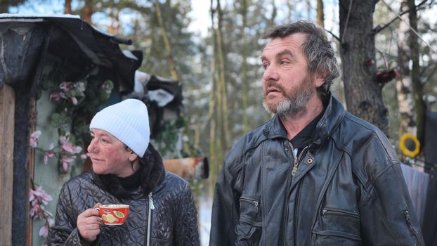 Homeless people are interviewed in the winter in the woods