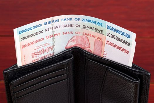 Old Zimbabwean banknotes - dollars  in the black wallet	