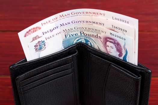 Currency of the Isle of Man - Pounds in the black wallet