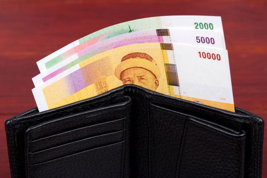 Comorian money - franc in black wallet