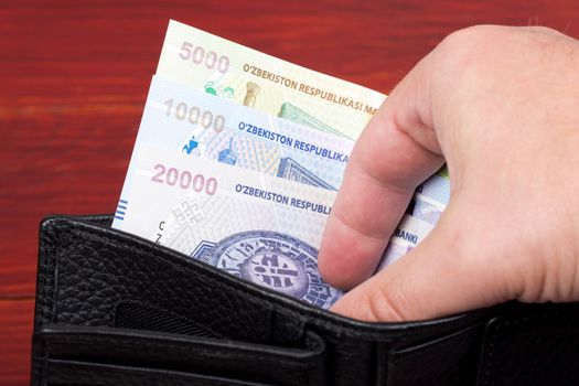 Uzbekistani money - som in the black wallet