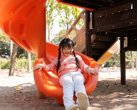 Happy children girl playing and having fun at the playground.