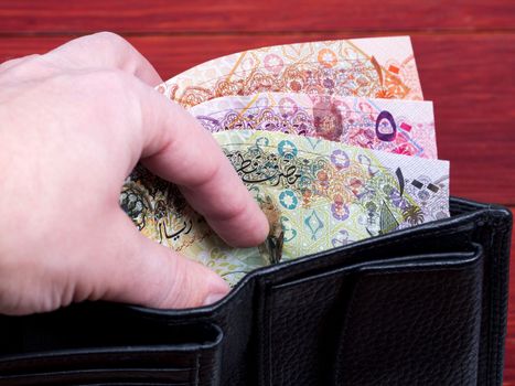 Qatari money - Riyal  in the black wallet