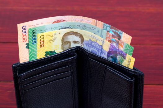 Costa Rican money - Colon in the black wallet