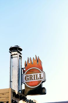 Nameplate affixed to the chimney on the roof of the building. Grill lettering. Close-up. High quality photo
