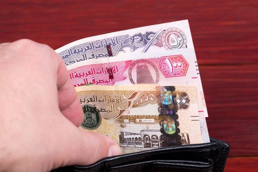 United Arab Emirates money - dirham in the black wallet