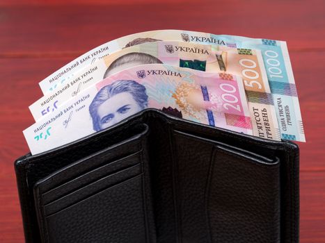 Ukrainian money - hryvnia in the black wallet